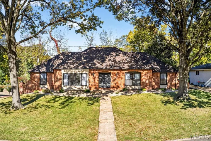 View of front of house featuring a front yard and brick siding