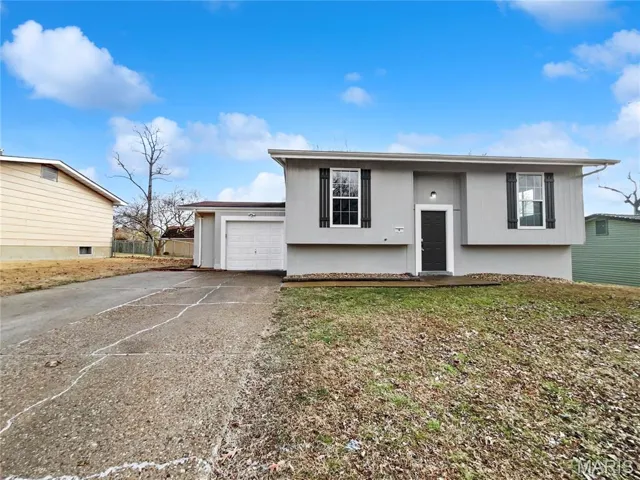 Split foyer home featuring driveway and a garage