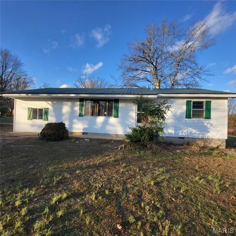 View of front facade with crawl space and a front yard