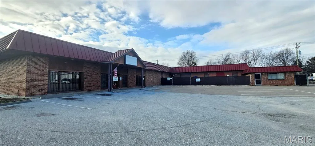 View of property featuring uncovered parking