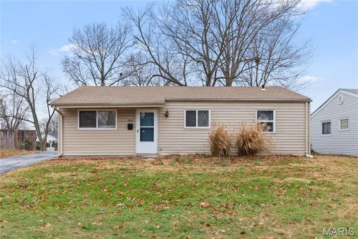 View of front facade with a front yard and roof with shingles