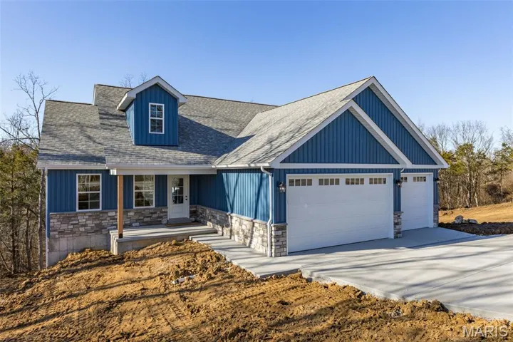 View of front of house featuring stone & siding, a porch, a shingled roof, concrete driveway, and an attached 3-car garage