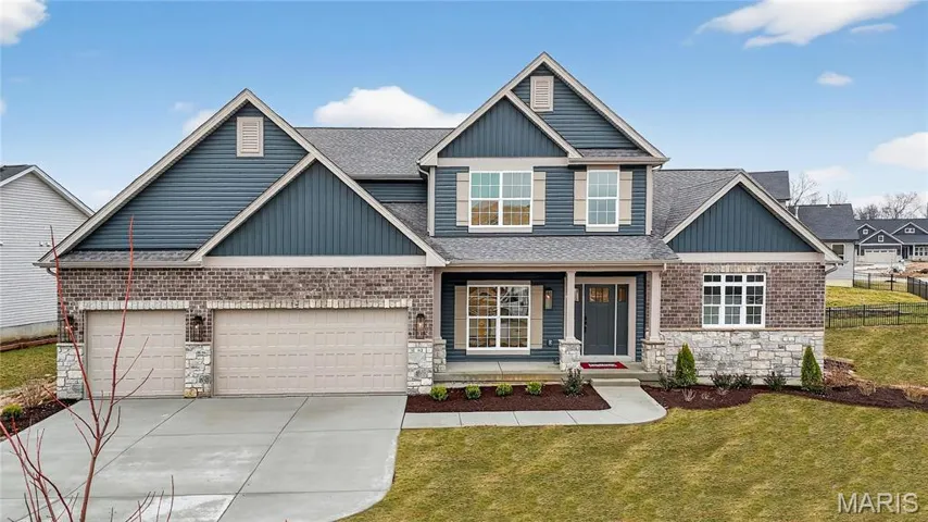 Craftsman inspired home with covered porch, stone siding, driveway, and a shingled roof