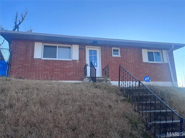 Single story home with stairway and brick siding