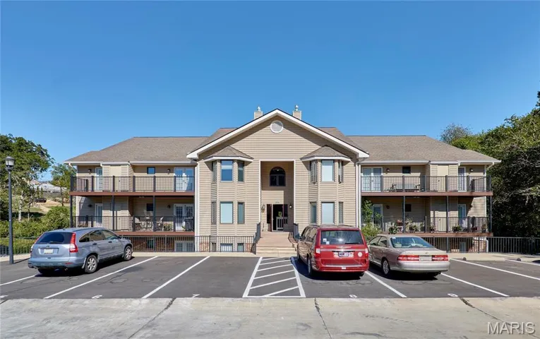 View of property featuring uncovered parking and a residential view