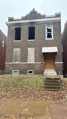 View of front facade with brick siding and entry steps