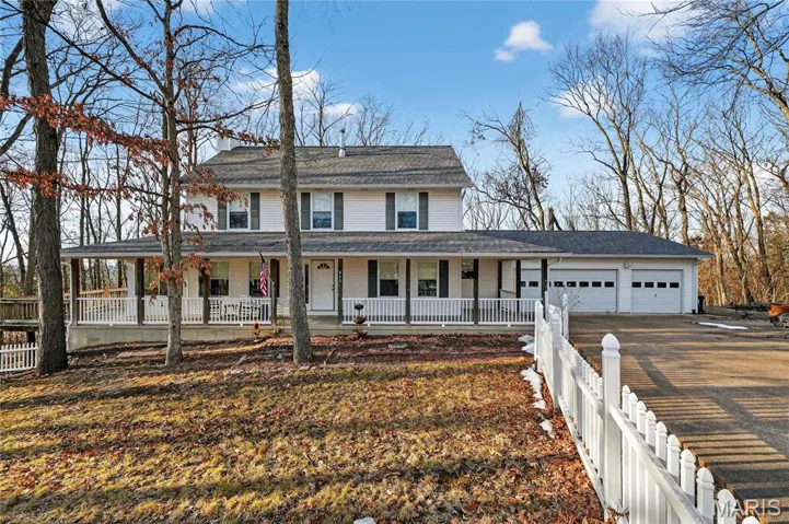 Front Elevation of this two-story with full length and wrap around porch.