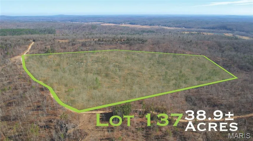 Aerial overview of property's location featuring property parcel outlined and a forest
