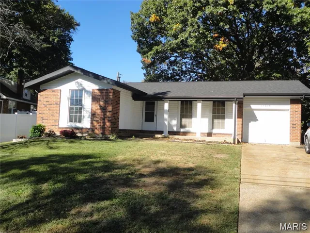 Ranch-style home with brick siding, a garage, a porch, and driveway