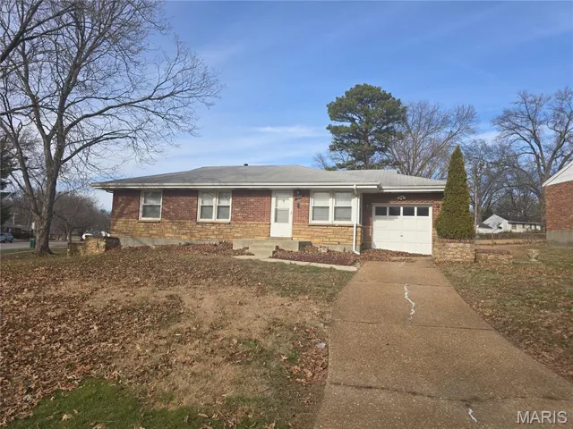 Ranch-style home with brick siding, an attached garage, and driveway