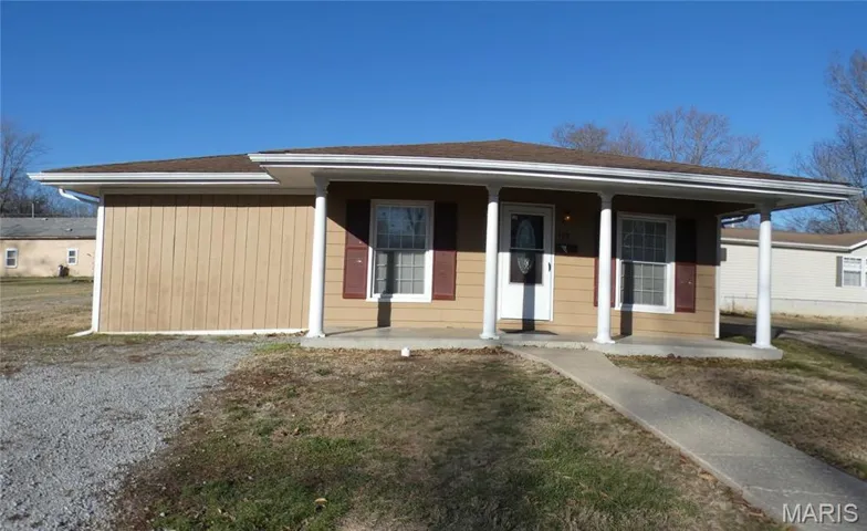 Bungalow-style home with a porch, a front yard, and roof with shingles