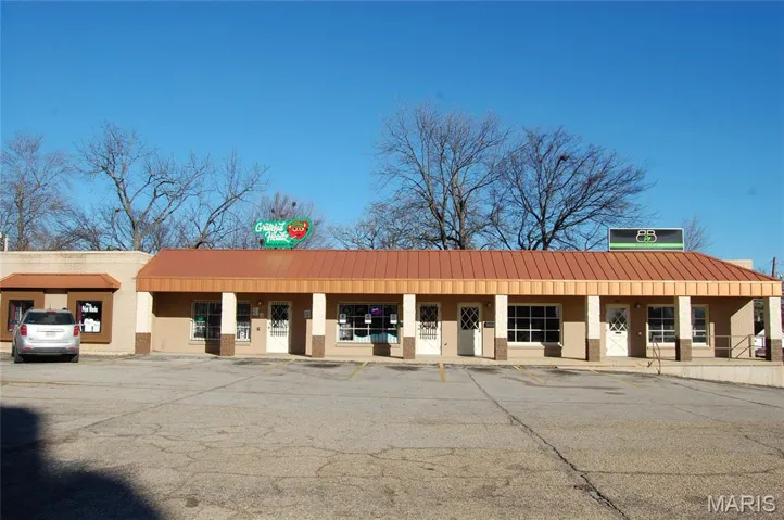 View of property with uncovered parking