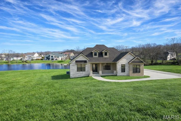 This is a rending - the Modbury plan on the Lake Lot at Cobblestone. The home owner can adjust colors and exact positioning of the home on the 1+ acre homesite.  Northern Star Homes - displays available at Stone Bridge, Washington