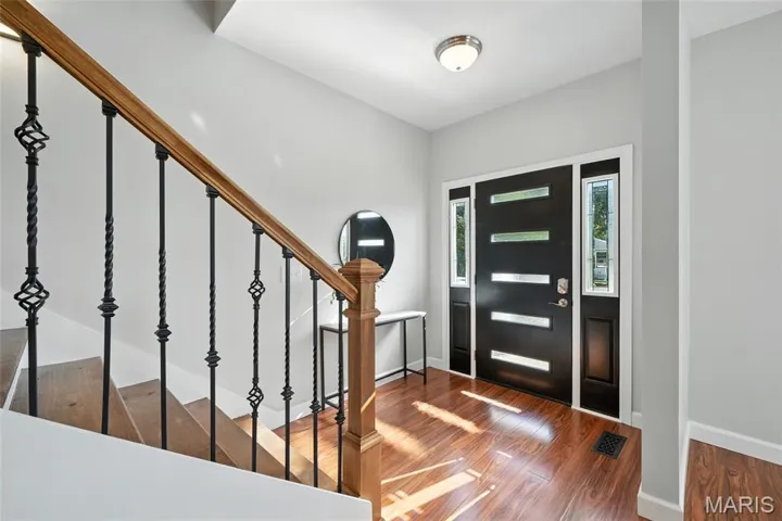 Foyer with stairway and vinyl finished floors