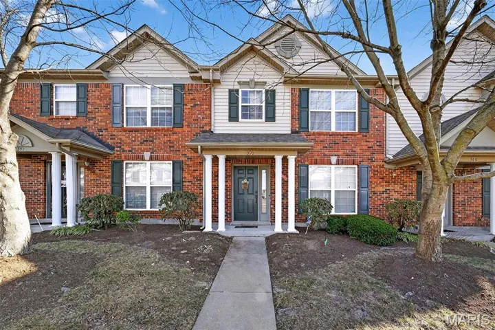 Front Elevation of Attached Townhome with Brick and Vinyl Siding and Covered Front Porch