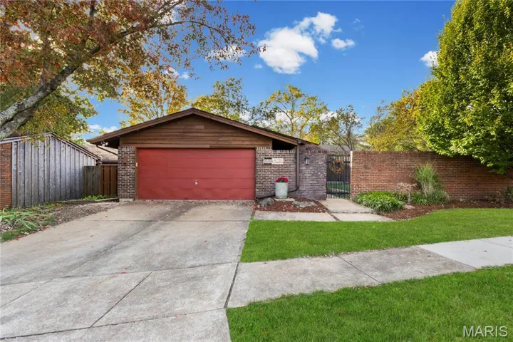 This updated midcentury ranch is set among mature trees and landscaped grounds, combining timeless architecture with a clean, well-maintained exterior.