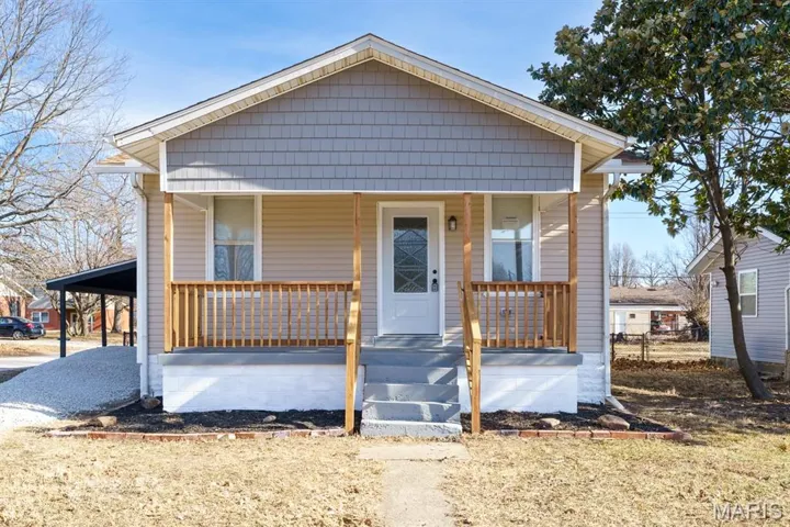 Bungalow-style home with a porch and a carport
