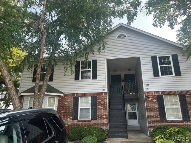 View of front of property featuring brick siding