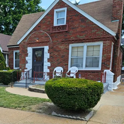 English style home with brick siding and roof with shingles