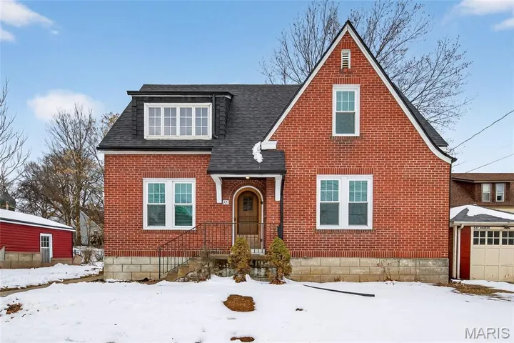 Front Elevation of Full Brick Home with a Detached One Car Garage