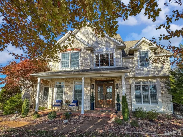 Traditional-style home featuring stone front and siding.  A covered porch.