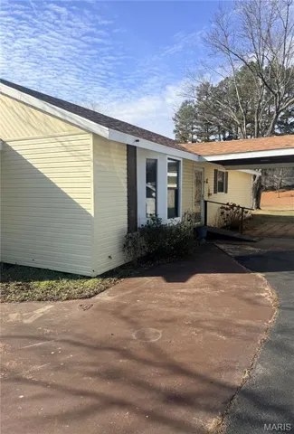 View of side of property with driveway