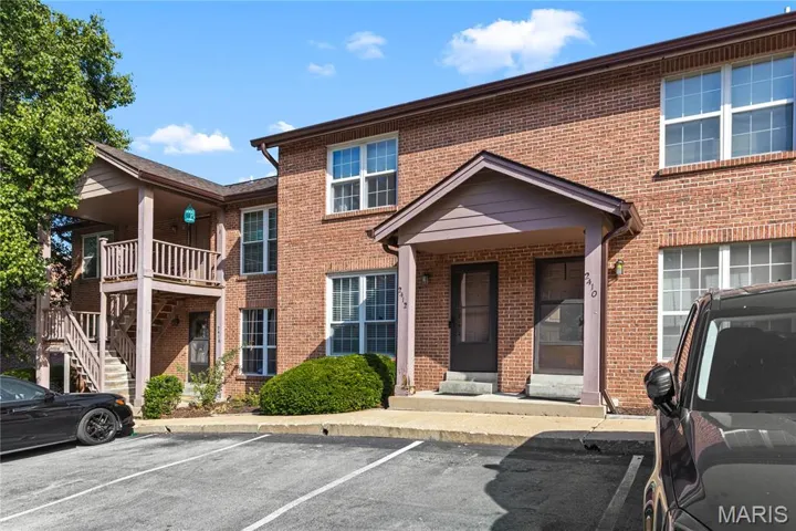 View of front facade parking and brick siding