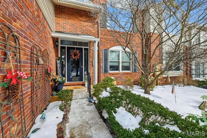 Property entrance featuring brick siding