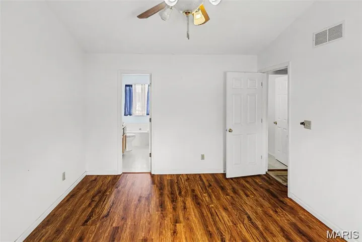 Upper level primary bedroom with vaulted ceiling