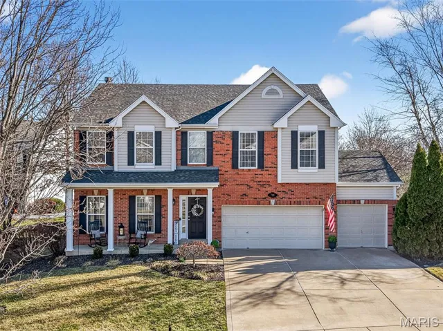 Impeccably Maintained Two Story with Brick, Vinyl Siding, Large Covered Front Porch and Three Car Garage