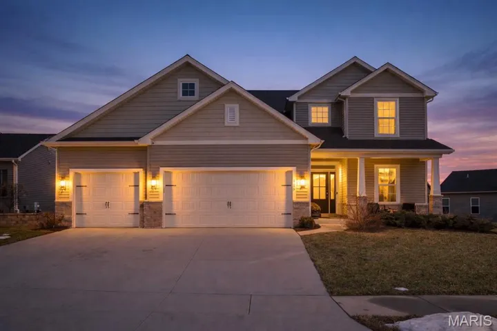 Craftsman-style home featuring stone and brick façade, with a HUGE oversized 3 car garage!
