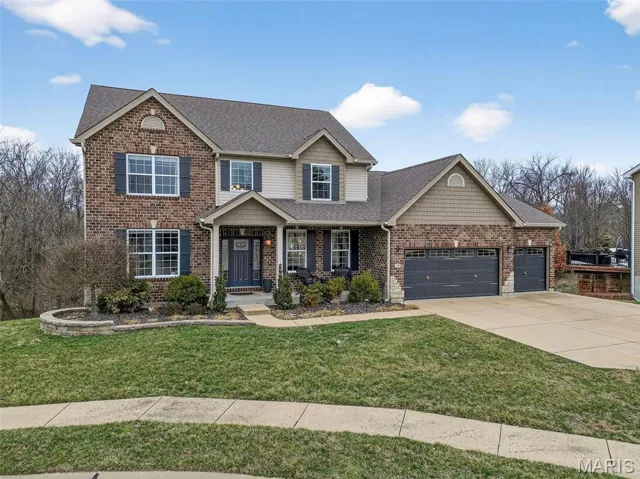 1.5 Story Home with Brick, Stone Accents, Vinyl and Shake Siding, 3 Car Oversized Garage on a Cul De Sac Lot Backing to Trees