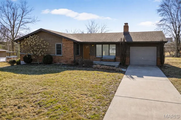 Brick and cedar elevation on this charming 3 bedroom 1.5 bath 1240 sqft ranch home