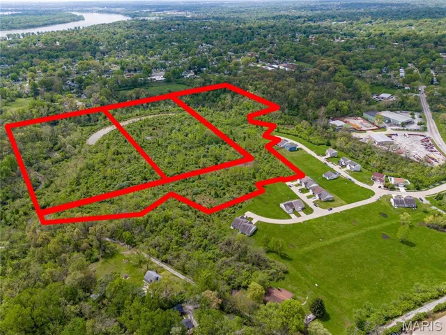 Aerial overview of property's location featuring a nearby body of water and property parcel outlined