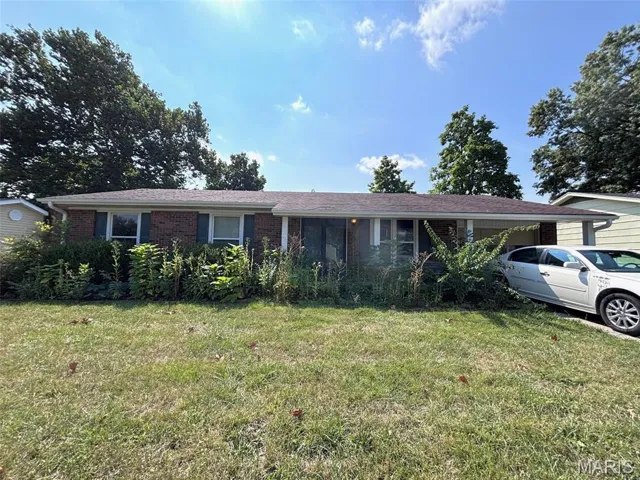 Ranch-style home with brick siding and a front lawn