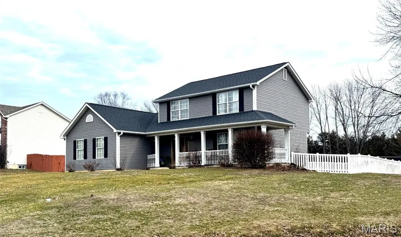 Traditional-style home featuring a wrap around porch