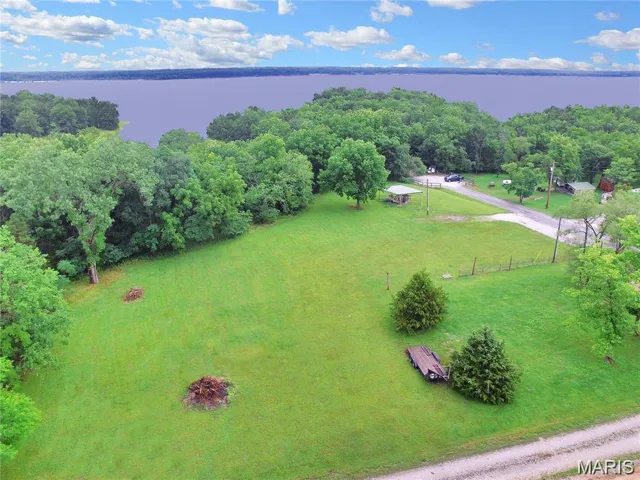 Great aerial view of this beautiful property, which sits near the tip of the peninsula at the center of Mark Twain Lake. The walking path next to the property walks right down to the cove.