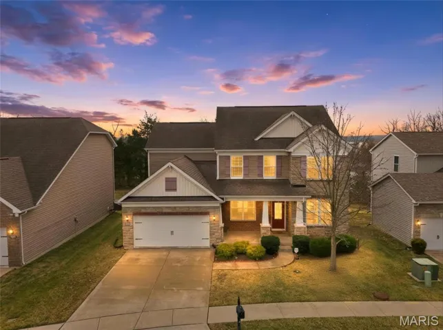 Craftsman inspired home with a porch, concrete driveway, a front lawn, a shingled roof, and stone siding
