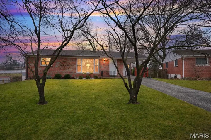 Ranch-style house with brick siding and driveway