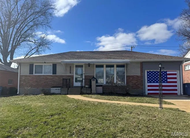 Updated bungalow w/finished lower level, attached garage & fenced yard.