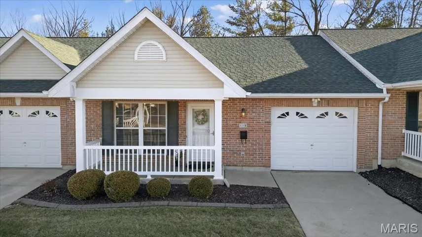 View of front facade featuring a porch, an attached garage, brick siding, and concrete driveway