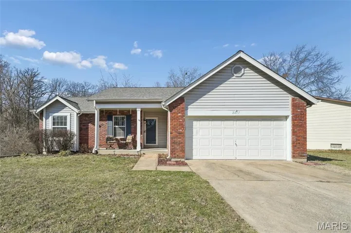 Ranch-style home featuring covered porch, driveway, a garage, a front lawn, and brick siding