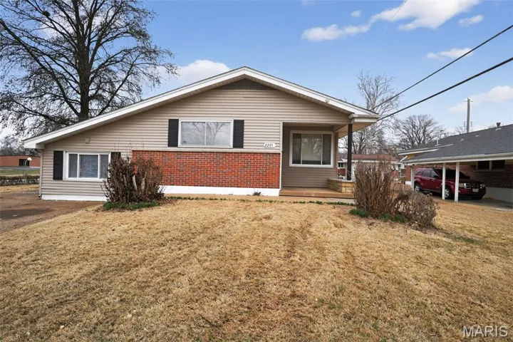 View of front facade with a front yard and brick siding