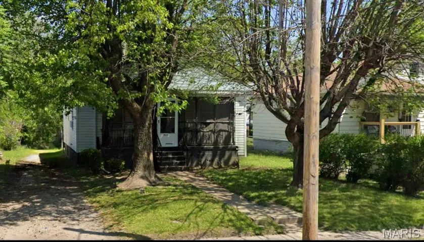 View of front of home featuring a front lawn and a sunroom