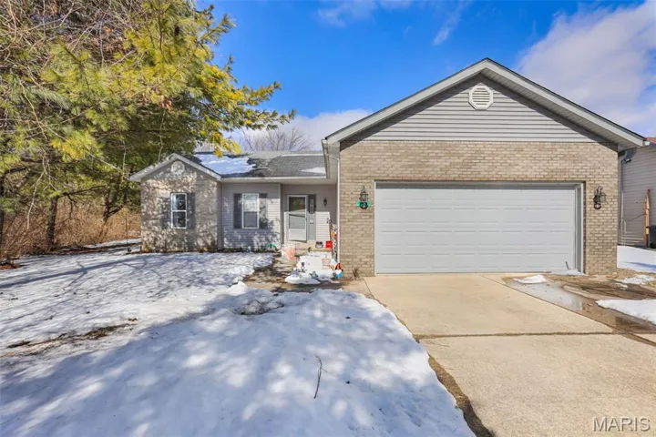 Ranch-style house with an attached garage, concrete driveway, and brick siding