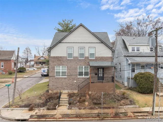 View of front of home with brick siding and a residential view