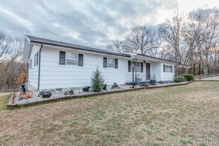 Single story home featuring a front lawn and a porch