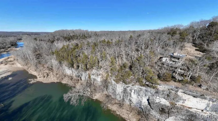 Bird's eye view of a heavily wooded area and a large body of water