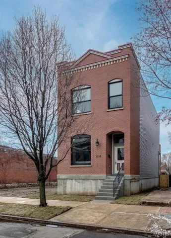View of front of home featuring brick siding