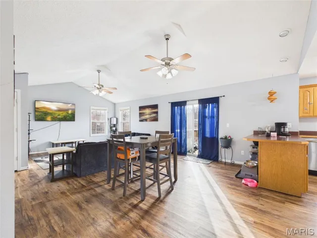 Dining room with wood finished floors and a ceiling fan